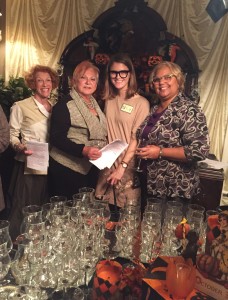 Lynn, Sue and Deborah greet Mallory, a new member, (second from right) at the wine tasting.