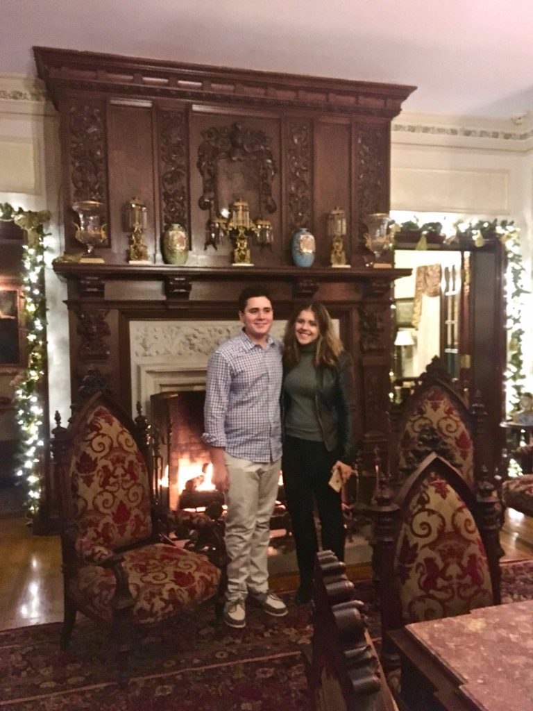 In from of the fire place in the gothic revival Buhl mansion, a scholarship recipient and her younger brother.